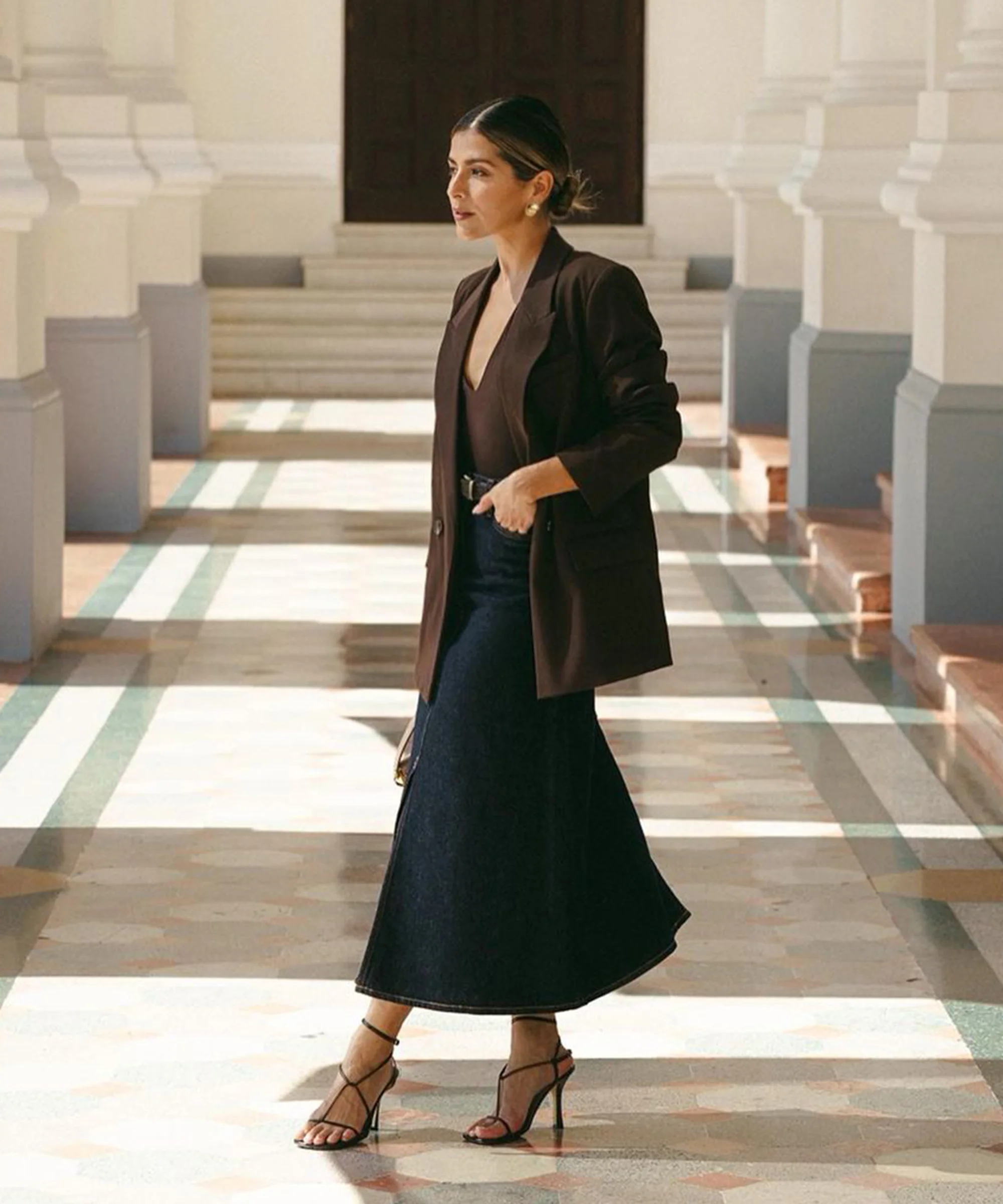 Pam Arias wearing brown blazer and black skirt for the office