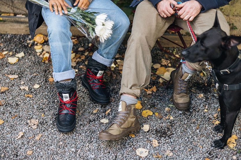 a person and a dog sitting on a bench